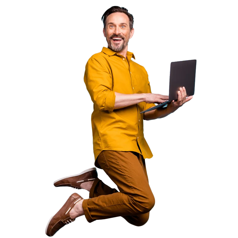 An excited business owner with laptop jumping for joy after signing up for a Business Receptionist call handling service free trial with Vodafone Business Answering.